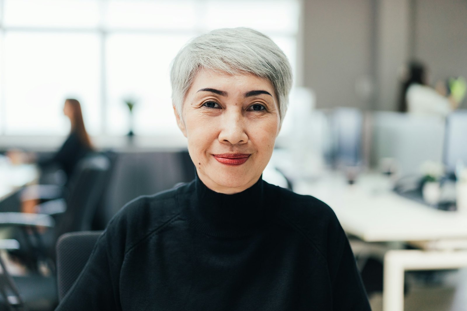 Asian senior female manager looking at camera